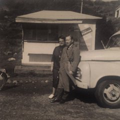 På bilden ser vi det legendariska paret Sahlén. Tore och Tant Sally som vi kallade henne. De tog över strandkiosken i Kyviks bad och båthamn. Den startades så vitt jag vet av Harald Rudolfsson och hans maka Lillemor Rudolfsson som parallellt drev Tennisstugan i Kullavik.  Sahléns bytte ut den lilla kiosken på bilden i andra hälften av 60-talet mot en större byggnad som innehöll en godis, tobak och fruktdel. Vidare en del som var korvkiosk. Denna kiosk var en naturlig plats för oss ungdomar att samlas vid. Känner stor tacksamhet till Tant Sally och Farbror Tore som var väldigt hyggliga mot oss ungdomar. På Sjuttiotalet tog paret Sahlén över snipens kiosk och drev den under några år. Bilden kommer från Sverker Dahl. Texten från Sverker Dahl och Dan Manhed